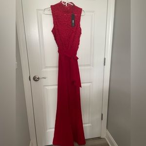Red sleeveless lace top zip up tie waist jumpsuit.